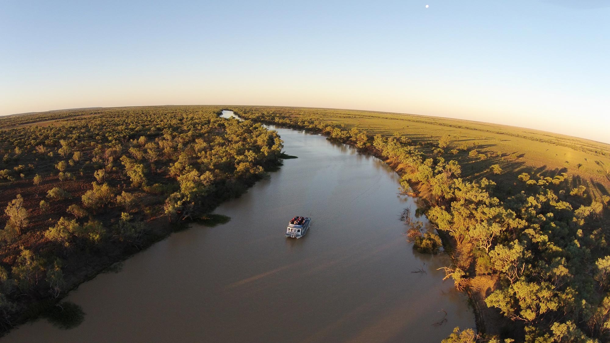 Aerial shot of the Longreach Explorer Boat heading down the Thomson River during the Outback Aussie Tours Sunset Cruise
