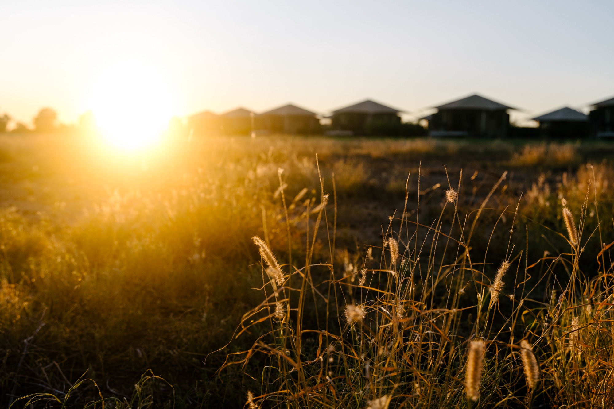 Sunset at Mitchell Grass Retreat with Glamping Tents in the background.